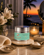 A premium jar of Frolana Natural Growth Factor Night Cream displayed on a round stone vanity tray. The glass cosmetic jar features a soft teal label and sits alongside a small dish of the cream, a lit candle, and white flowers, with a serene sunset over a tropical ocean beach.