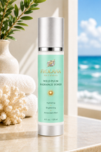 Frolana Natural Wild Plum Radiance Toner with Pearl Aqua label on a coastal stone ledge